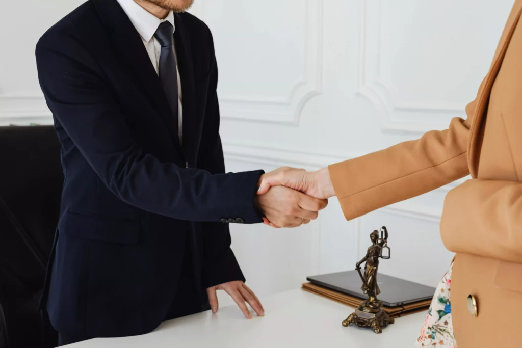 lawyer shaking hands with client
