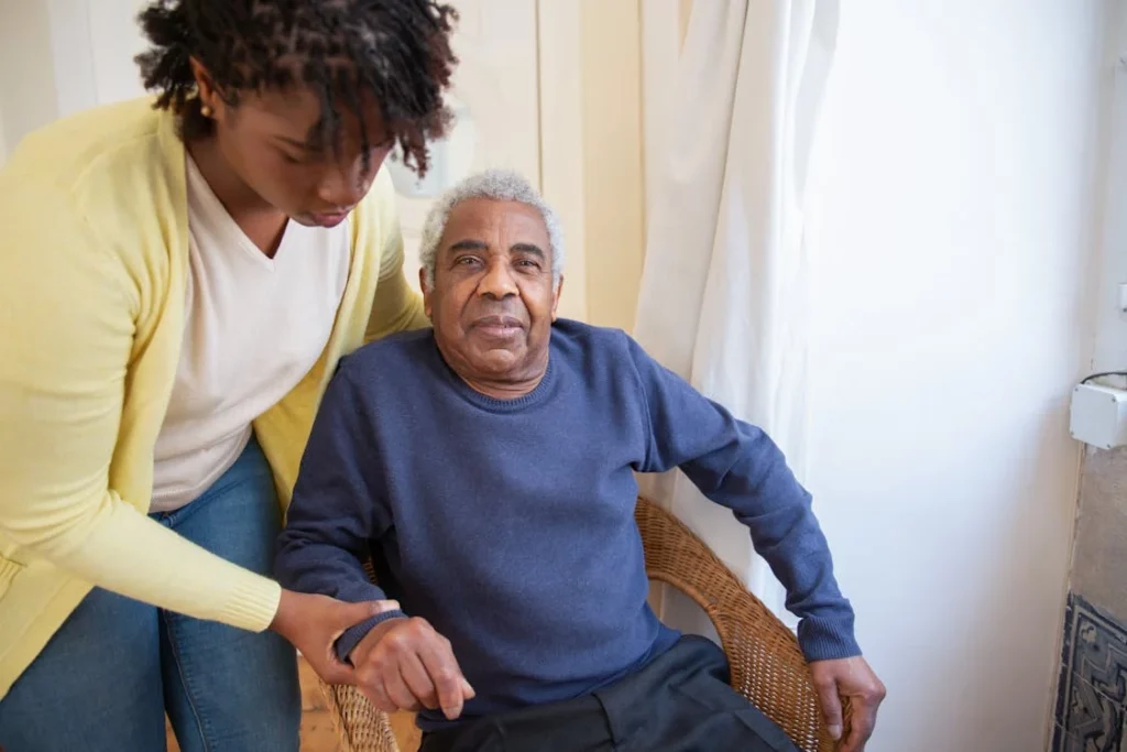 nurse assisting an elder man