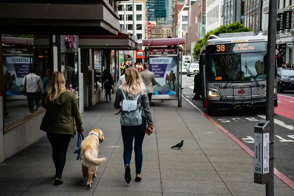 busy sidewalk with a bus