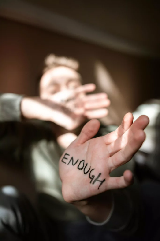the word enough written on a woman's palm