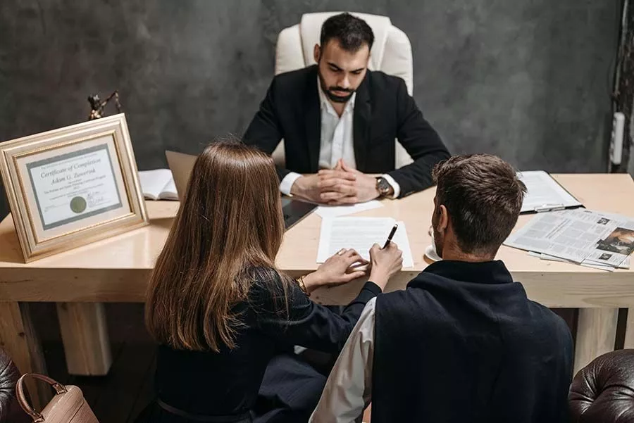 attorney with client signing a document