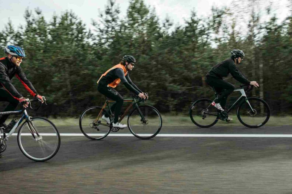 three bicycle riders