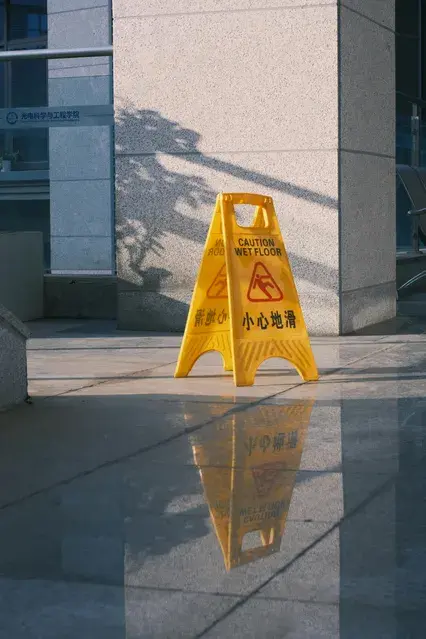 yellow wet floor sign outside a building