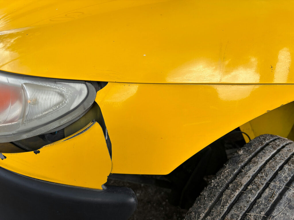damaged yellow car bumper