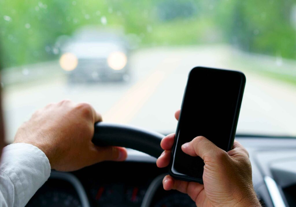 man texting while driving