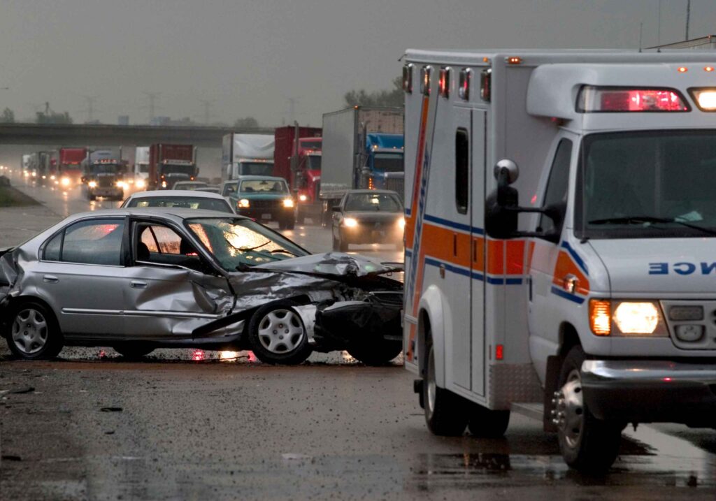 sedan car crash behind an ambulance