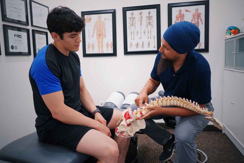 Doctor showing a spine model to a patient