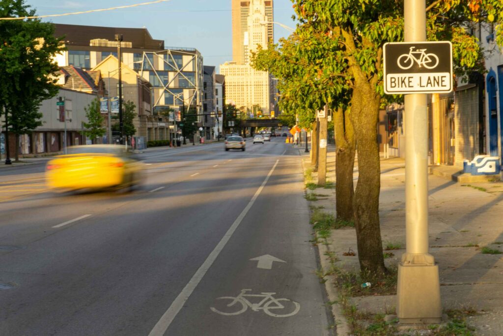 City street with a marked bike lane and sign
